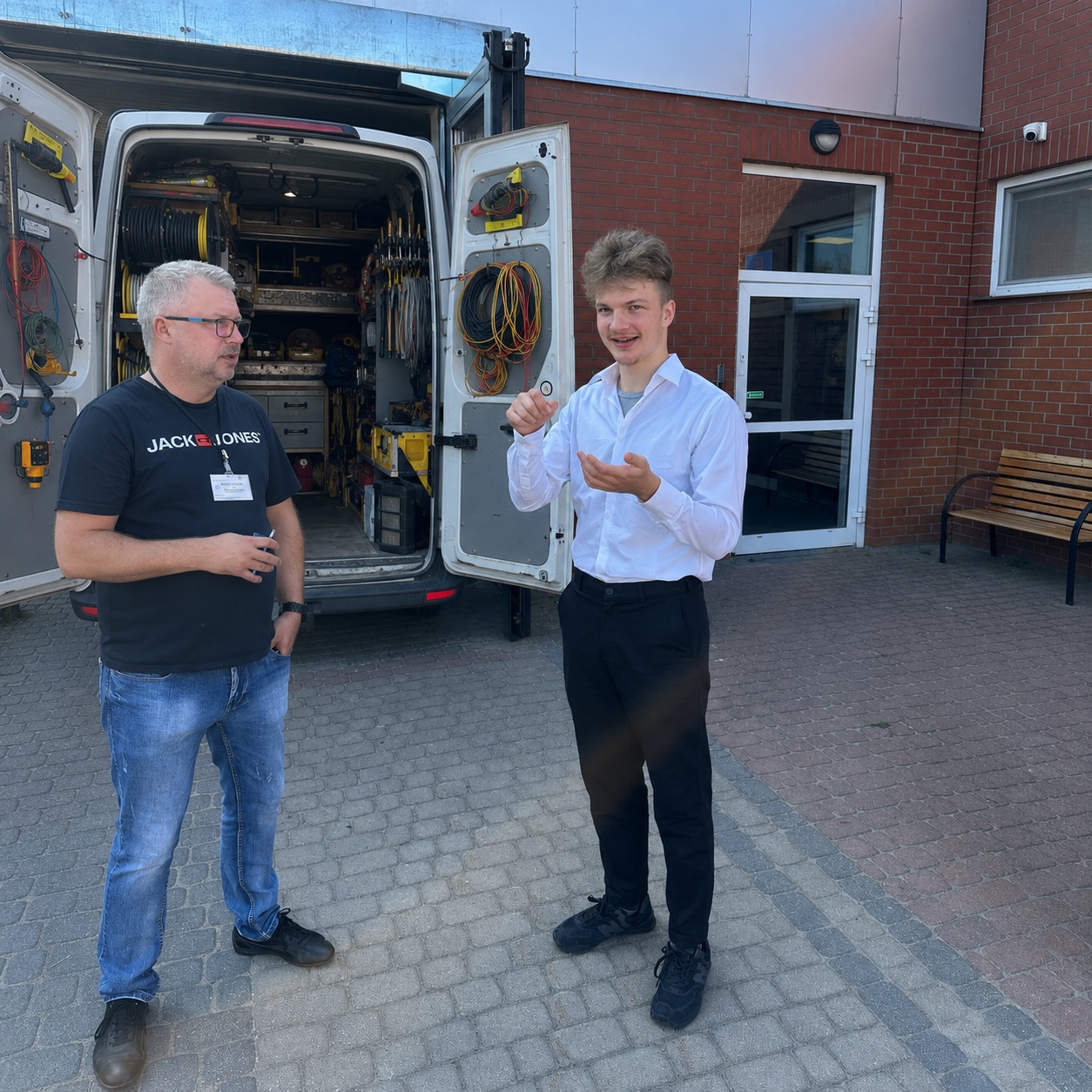 Robert on-site at a factory, walking a technician through how Darwin runs the shop